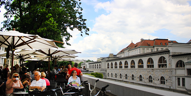 Ljubliana Locals enjoying coffee by the river in Old Town