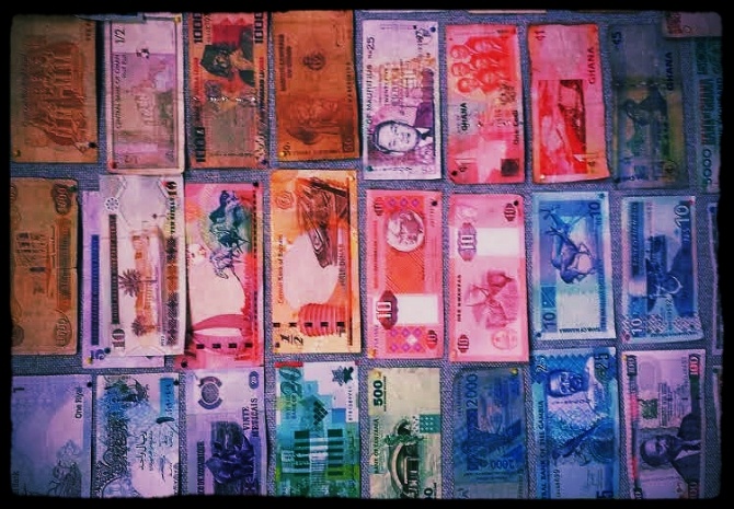 Wall of International Currency at AIRINC's Headquarters in Cambridge, MA. Currency credit to AIRINC's international cost of living survey team.